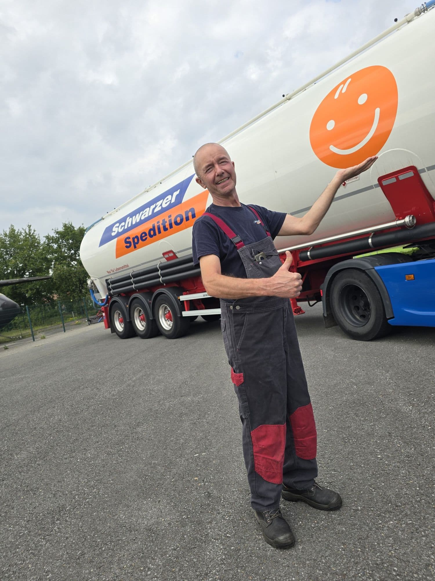 Fahrer der Schwarzer Spedition mit dem Smiley vor seinem Silozug